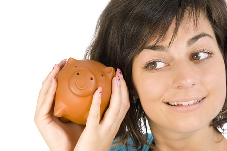 Proud girl holding piggy bank full of savings の写真素材