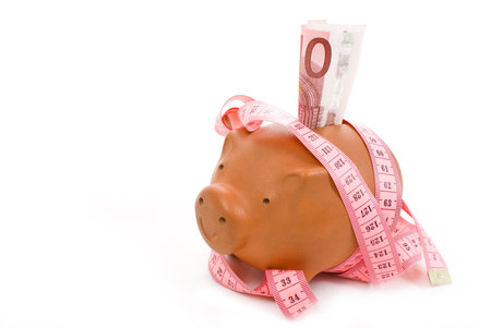 Brown piggy bank isolated on whiteの写真素材