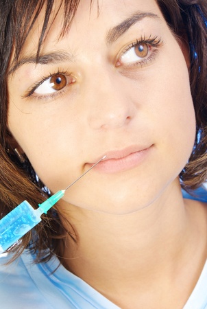 Beautiful woman recieving a botox injection in her lip の写真素材
