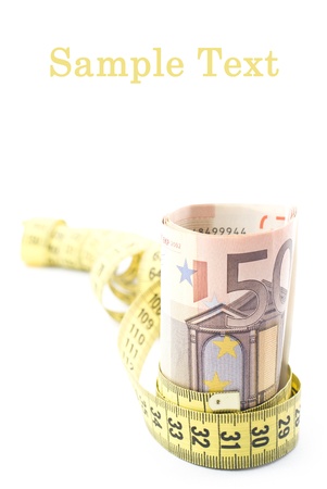 Rolled up money and measure tapeの写真素材