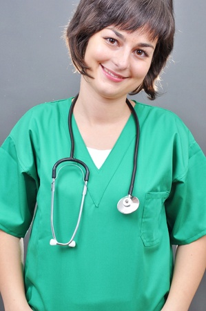 Attractive lady doctor on a over gray background の写真素材