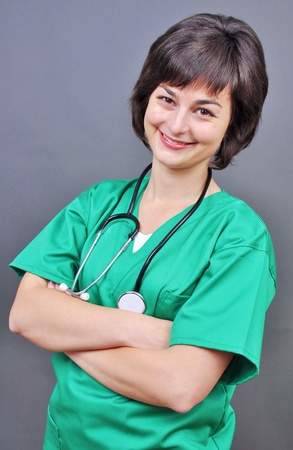 Attractive lady doctor on a over gray background の写真素材