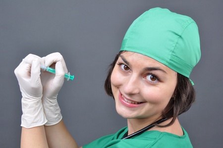 Attractive lady doctor on a over gray background の写真素材