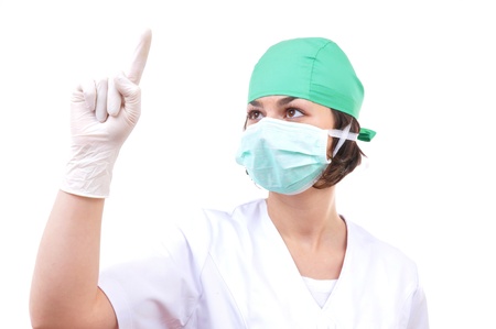 Closeup portrait of young female surgeon pointing at copyspace の写真素材