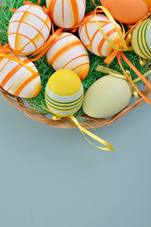 Colorful Easter Eggs basket set on blue background の写真素材