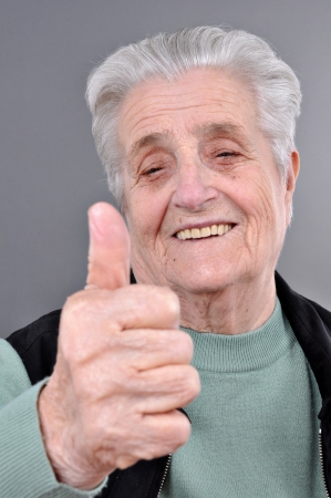 Happy old woman with thumb upの写真素材