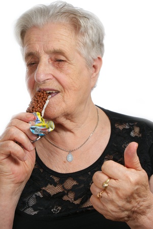 Old woman eating muesliの写真素材