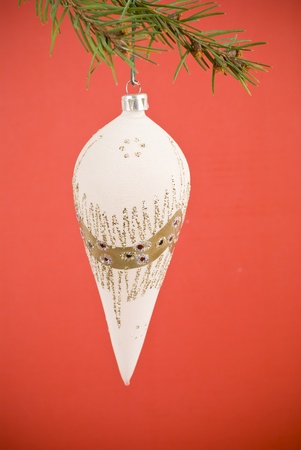 Closeup photo of a nice colorful Christmas decoration bauble hanging on Christmas tree. Isolated on white. の写真素材