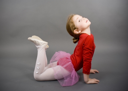 little girl in a red elegant dressの写真素材