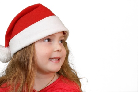 Little girl in Christmas hat , isolated on white の写真素材