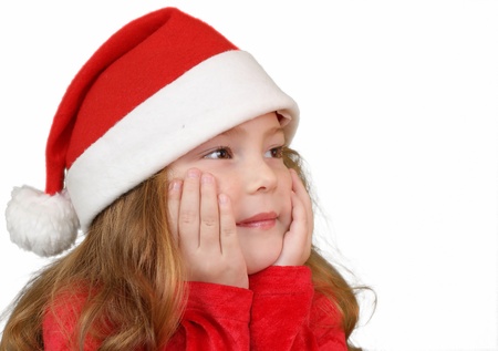 Little girl in Christmas hat , isolated on white の写真素材