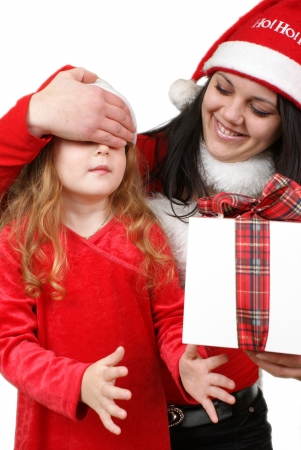 Little girl friend gives a holiday gift in red box with white ribbon. の写真素材