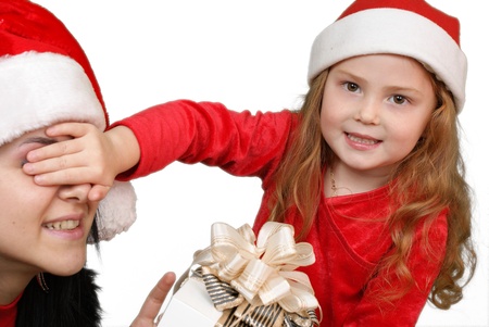 Little girl gives a holiday gift in red box with white ribbon  の写真素材