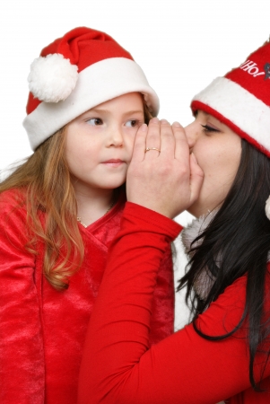 Girl whispers in child ear の写真素材