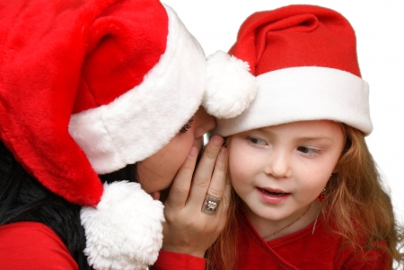 Girl whispers in child ear の写真素材