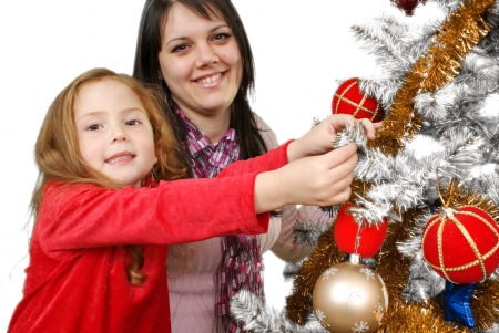 Two Young happy woman decorating the Christmas tree  Studio shot  White background の写真素材