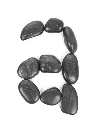 Small letter 'a' made of stones isolated on white の写真素材