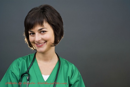 Attractive lady doctor on gray background の写真素材