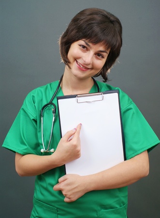 Attractive lady doctor on gray background の写真素材