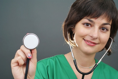 Attractive lady doctor on a over gray  background の写真素材