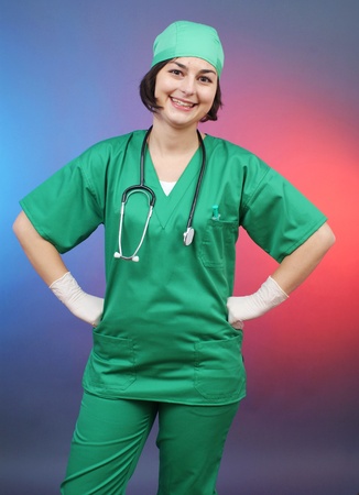 Attractive lady doctor on a over gray  backgroundの写真素材