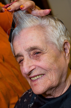 Old woman having a hair cutの写真素材