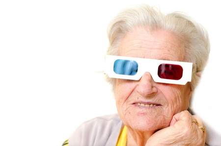 Senior woman wearing 3d glasses isolated on white backgroundの写真素材