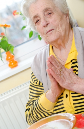 Senior woman folded her hands in prayerの写真素材