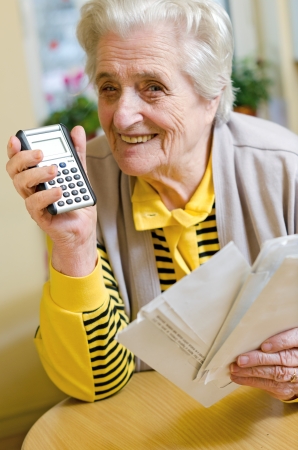 Old woman calculating the paymentsの写真素材