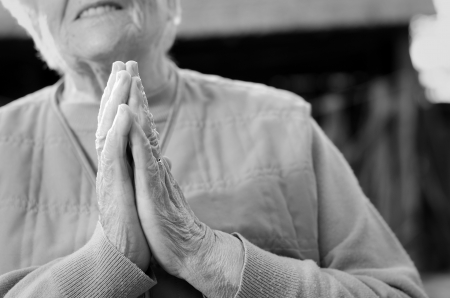Senior woman holding her hands togetherの写真素材