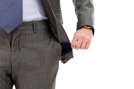 businessman standing isolated on the white background and showing his empty pocketの写真素材