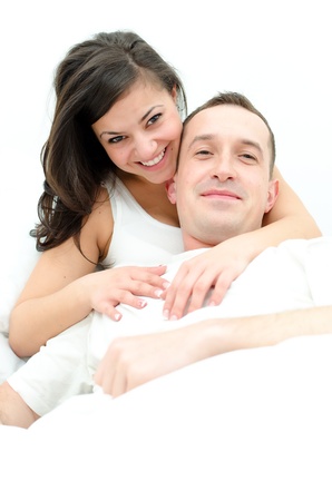 Young man and woman in bedの写真素材