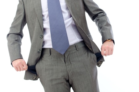 businessman standing isolated on the white background and showing his empty pocketの写真素材