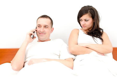 Man talking on the phone, woman upsetの写真素材