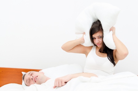 Snoring man. Couple in bed, man snoring and woman can not sleep,の写真素材
