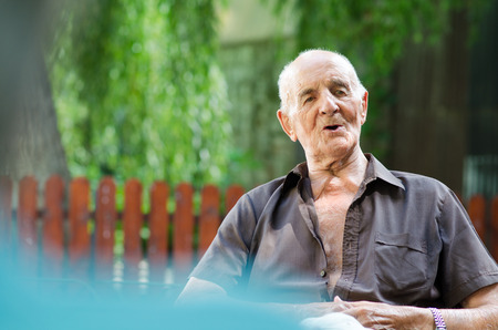 Happy senior man sitting and relaxingの写真素材