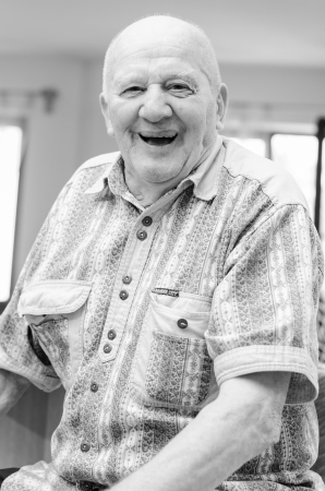 Happy senior man sitting indoor and smilingの写真素材