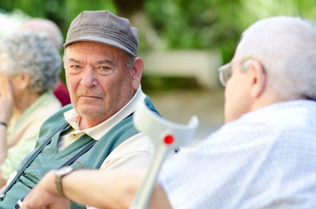 Two gray-haired man talkingの写真素材
