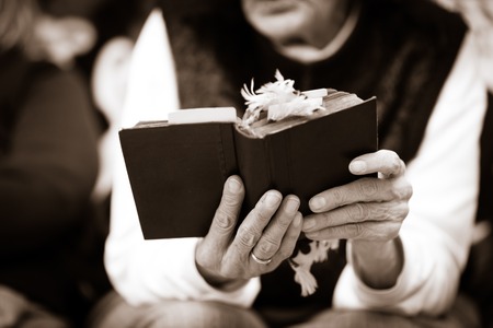 woman with hands holding Bibleの写真素材