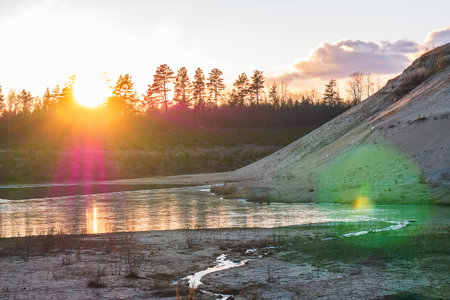 Sunset in the background of a large mountain made of sand. Sunset in the background of an abandoned quarry.の写真素材
