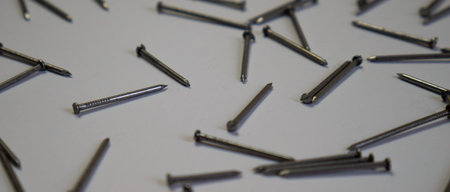 Flat lay nails on a white background. Frame for text. Construction tools, the theme of construction....