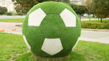  Green soccer ball made of grass. Object in a city park.の写真素材