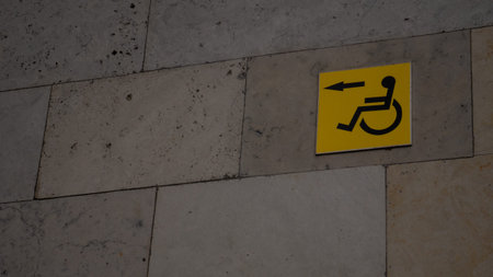 Yellow sign with a disabled person. There is place for copyspace. Wheelchair on a yellow background.