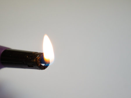 An electronic lighter. Burning the kitchen stove. Fire from a lighter. Adaptation for arson. 