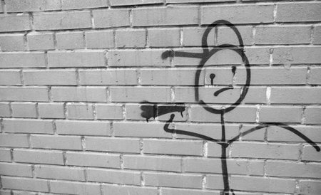 The figure of a drawn man holding a megaphone. There is a place for copyspace. Photo with a red background.の写真素材