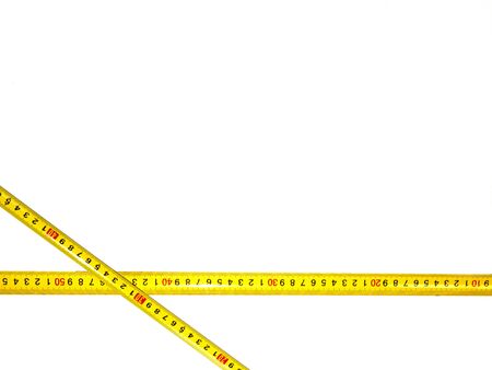 Isolated tape on a white background. Measurements in centimeters in construction or measurement of waist width. Yellow isolated ribbon with divisions on a white background.の写真素材