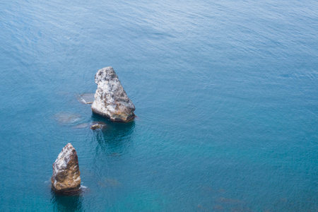 Two huge stones in the middle of the sea. two huge rocks in the middle of the ocean. beautiful view of the sea.の写真素材