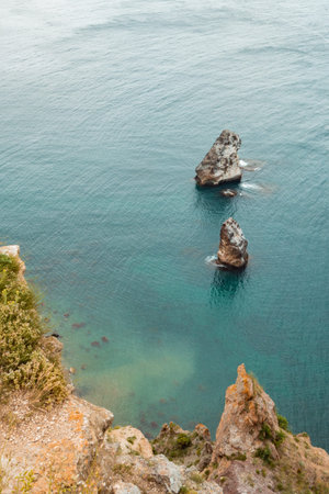 Two huge stones in the middle of the sea. two huge rocks in the middle of the ocean. Beautiful view of the sea.の写真素材