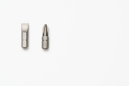 Choices: Phillips number 2 or flathead screwdriver bits on a white backgroundの写真素材