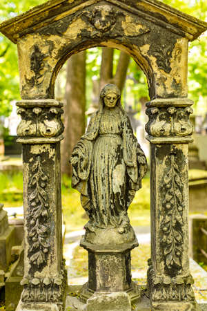 Historic cemetery in the city center of Warsaw. Green trees, monuments, crosses and sculptures. Old PowÄzki.の写真素材
